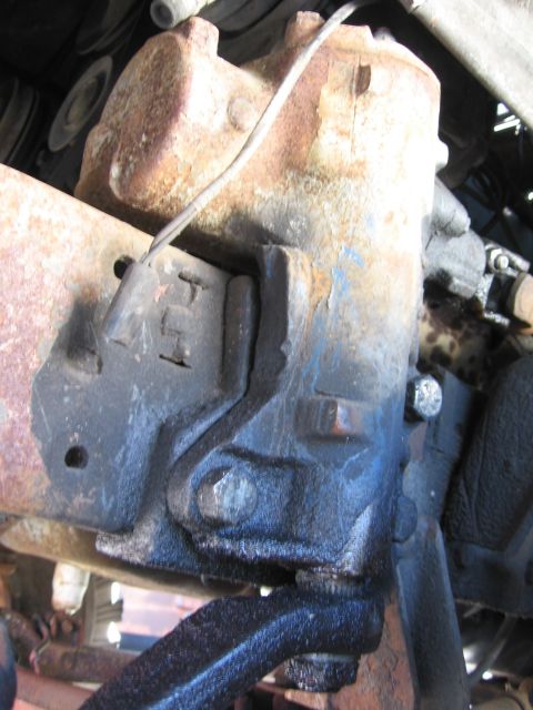1974 Ford F-100 - This image shows a close-up view of a rusty steering gear box mounting bracket, likely from an older vehicle.
