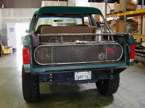 1989 Ford Bronco - Rear view of a 1989 Ford Bronco, modified with a cargo rack and aftermarket bumper.