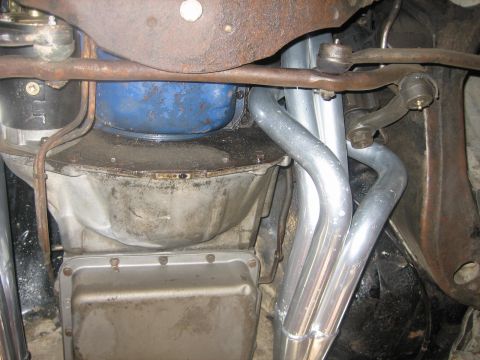 1976 Ford Ranchero - This photo shows the underside of a vehicle, focusing on the exhaust system and transmission components.