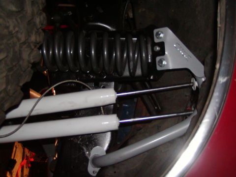 1991 Ford Bronco - Suspension parts, including a coil spring and shocks, with a bracket labeled 'EDGE'.
