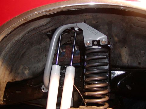 1991 Ford Bronco - This image shows the suspension system of a vehicle, focusing on the shocks and coil spring assembly.