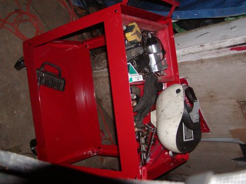 1991 Ford Bronco - A red toolbox is open, revealing various tools and a welding helmet stored within.