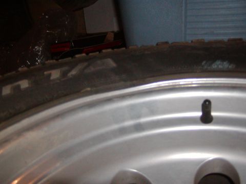 1991 Ford Bronco - A close-up view of a tire and wheel assembly, with visible text on the tire sidewall and a Supermotors.net watermark.