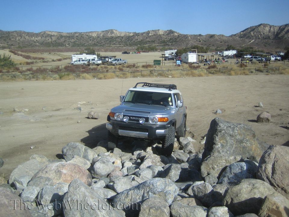 Silver Toyota FJ Cruiser navigating rocky terrain