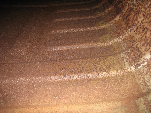 1976 Ford Ranchero - Heavily rusted metal interior with visible horizontal ridges and discoloration.