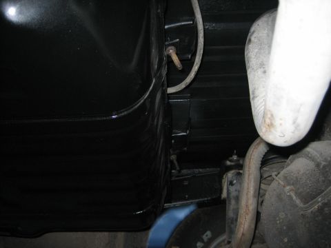 1976 Ford Ranchero - Close-up view of a vehicle's undercarriage, focusing on the gas tank and exhaust system.