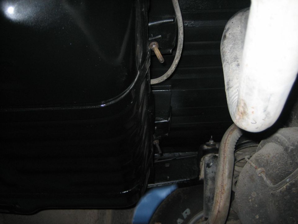 Black gas tank and exhaust pipe under a vehicle