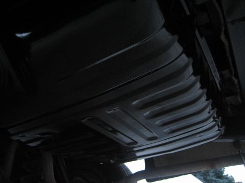 1976 Ford Ranchero - Underside view of a vehicle's ribbed fuel tank, showing its structural details.