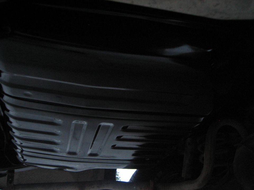 Black gas tank with horizontal ridges and rectangular cutouts