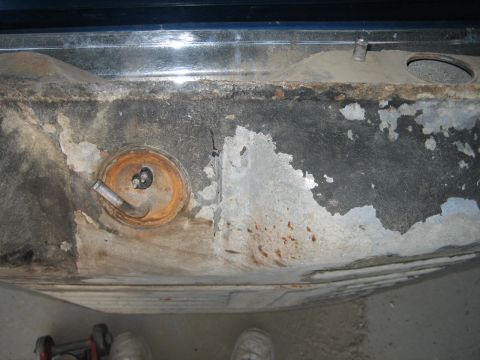 1976 Ford Ranchero - Underside view of a corroded gas tank, showing signs of wear and tear.