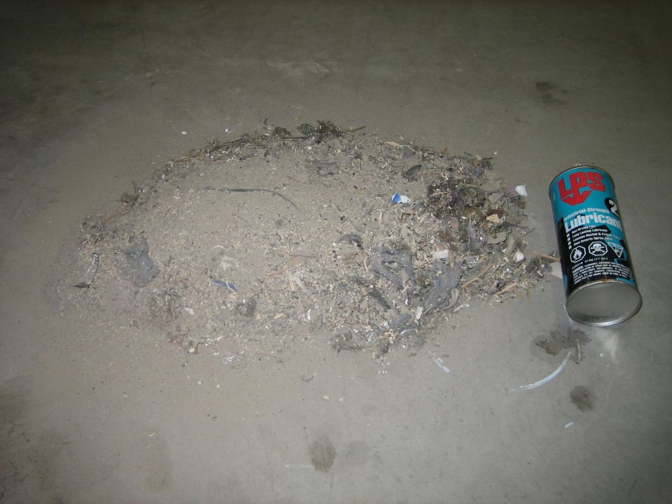 Pile of debris next to a can of LPS lubricant