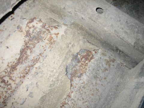 1976 Ford Ranchero - Undercarriage shows significant rust and corrosion on metal parts.