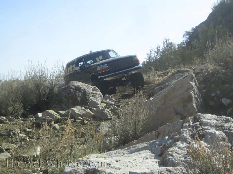 Dark SUV climbing rocky terrain, 1992 Ford Bronco