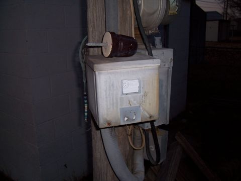 2004 Aston Martin Virage - Outdoor electrical equipment including a meter and junction box attached to a wooden pole.