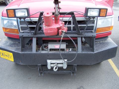 1979 Chevrolet Blazer - Front view of a red truck equipped with a winch and plow mounting hardware.