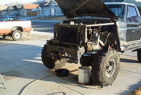 1986 Ford Bronco - Ford Bronco front end undergoing modification, with a second truck visible in the background.
