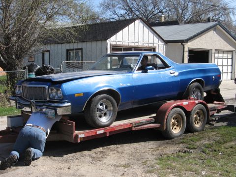 1976 Ford Ranchero - Loading a blue 1976 Ford Ranchero onto a trailer for transport.