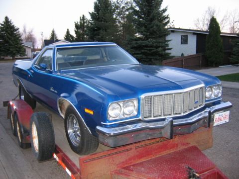 1976 Ford Ranchero - A blue 1976 Ford Ranchero is seen on a trailer, viewed from the front.