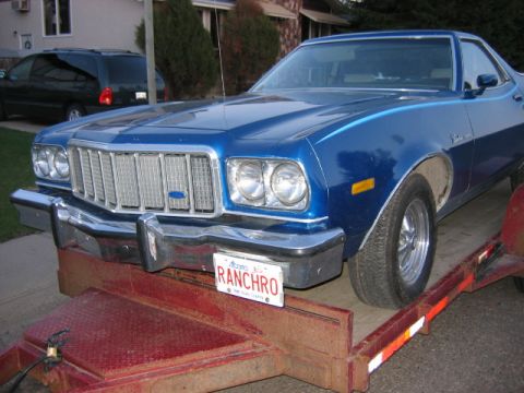 1976 Ford Ranchero - Front view of a blue 1976 Ford Ranchero being transported on a trailer.