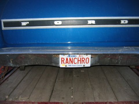 1976 Ford Ranchero - The rear of a blue Ford vehicle displays an Alberta license plate reading RANCHRO.