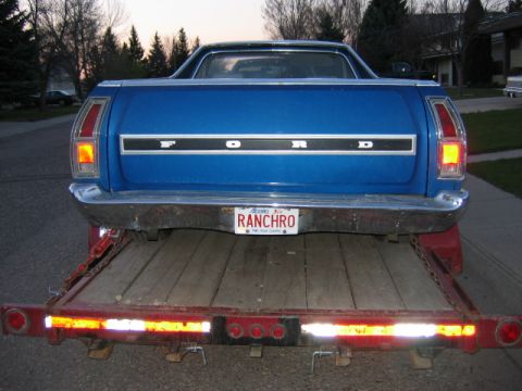 1976 Ford Ranchero - Rear view of a blue 1976 Ford Ranchero being transported on a trailer.
