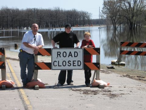 1976 Ford Ranchero - A road is closed due to flooding, with three individuals posing for a photo.