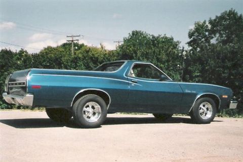 1976 Ford Ranchero - A blue 1976 Ford Ranchero is seen from the side under a clear sky.