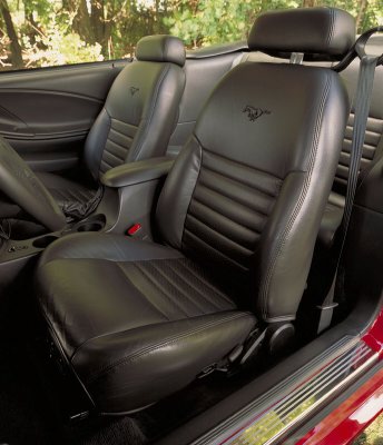 2003 Ford Mustang - Interior view of a 2003 Ford Mustang convertible, its black leather seats with embossed Mustang logos.