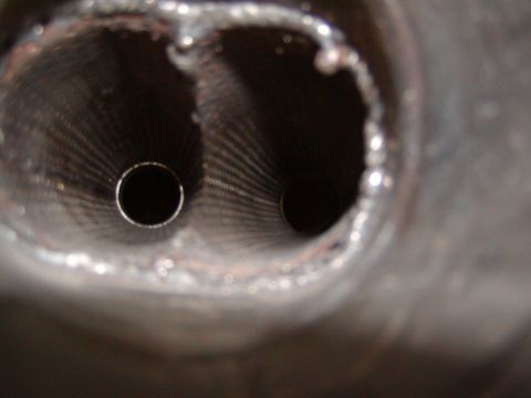 1991 Ford Bronco - A close-up view shows the interior of dual exhaust pipes, revealing their internal construction.