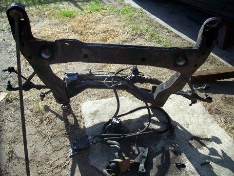 1992 Ford Taurus - Subframe assembly, including steering rack and power steering pump, removed from a vehicle.