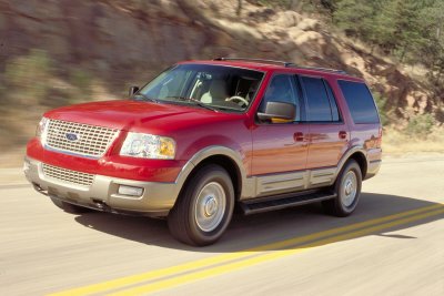 2003 Ford Expedition - This red 2003 Ford Expedition is captured in a 3/4 front view on a paved road.