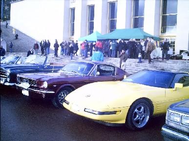 1991 Ford Crown Victoria - A yellow Chevrolet Corvette C4 is parked alongside other vehicles at an outdoor event.