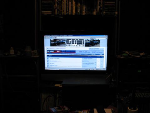 1997 Ford Crown Victoria - A computer screen displays a car forum, a banner with two vehicles and a chat room interface.