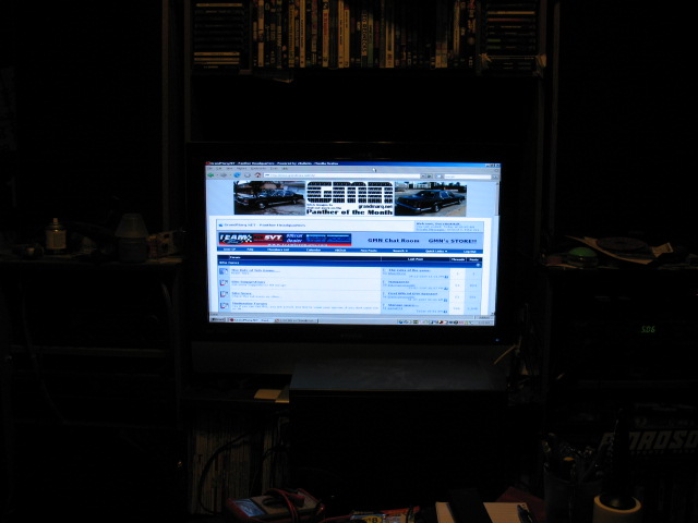 Computer screen displays a car forum with two cars in the banner image
