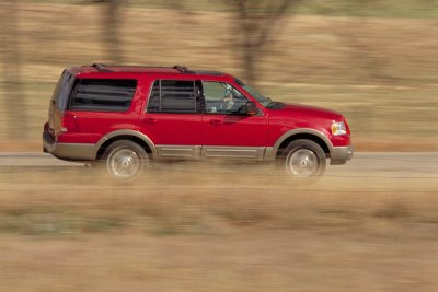 2003 Ford Expedition - Red 2003 Ford Expedition captured in motion on a rural road.