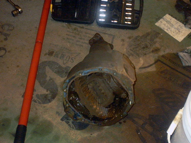 Differential assembly on floor with tools nearby