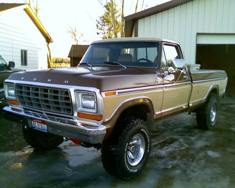 1979 Ford F-150 - A two-tone brown and tan 1979 Ford F-150 pickup truck is parked in front of a garage.