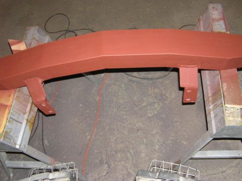 2000 Chevrolet Tahoe - A red front bumper, possibly undergoing restoration, is shown mounted on sawhorses.