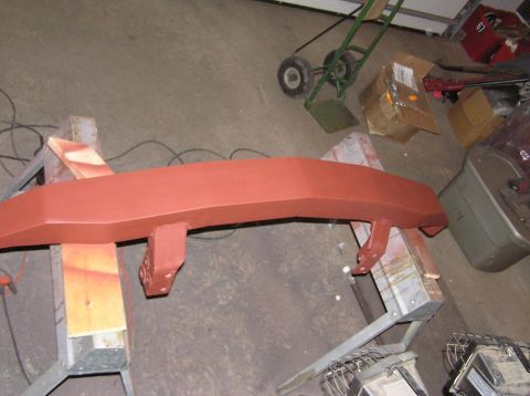 2000 Chevrolet Tahoe - Bumper assembly in primer, supported by sawhorses, with garage background.