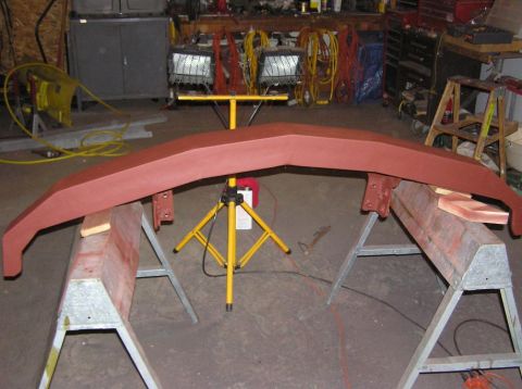 2000 Chevrolet Tahoe - A red front bumper is shown on sawhorses in a workshop setting.