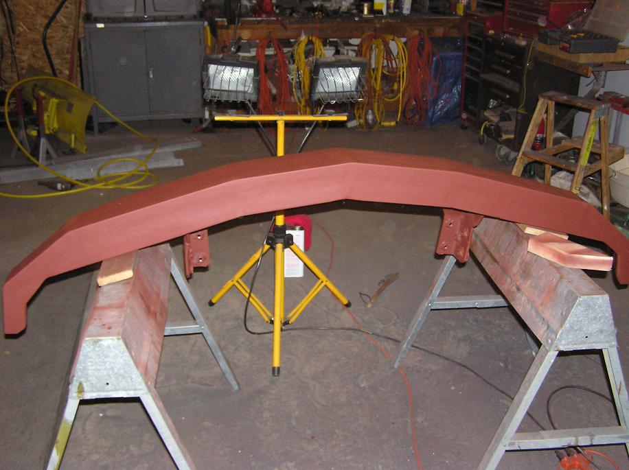 Red front bumper on sawhorses