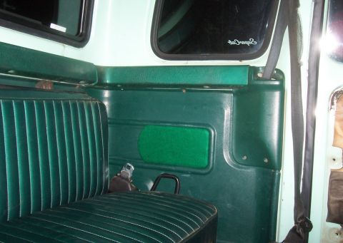 1994 Ford F-150 - Interior view of a truck, showing the green bench seat and door panel details.