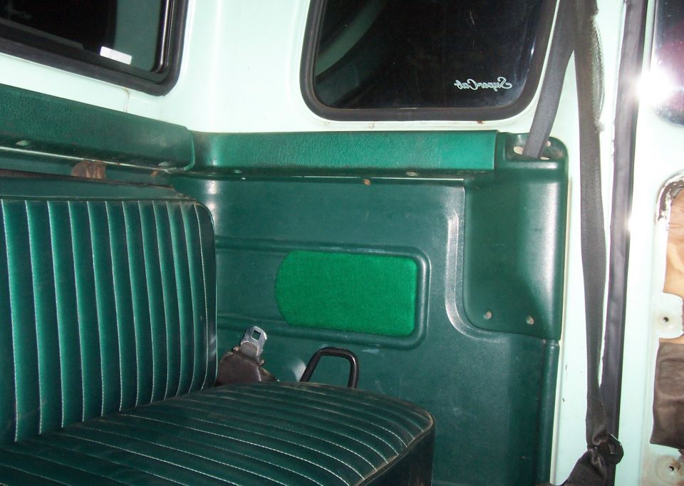 Green bench seat and door panel interior of a truck