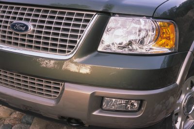 2003 Ford Expedition - Close-up of the front of a 2003 Ford Expedition, highlighting the grille and headlight assembly.