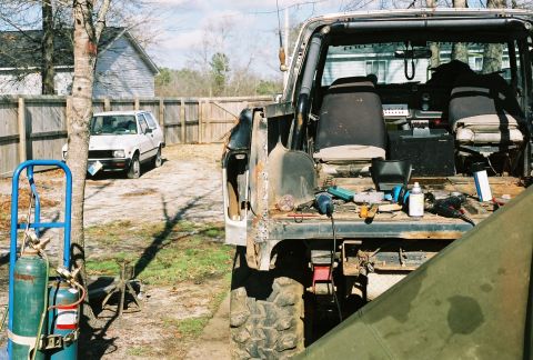 1978 Ford Bronco - Tools and equipment are laid out in the rear of a modified off-road vehicle.