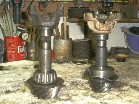 1986 Ford Bronco - Close-up view of two automotive differential gear assemblies and associated yokes.