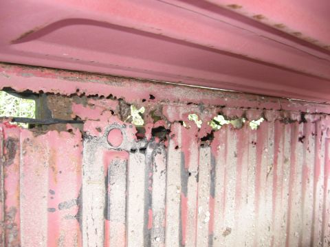1974 Ford F-100 - Heavily rusted metal panel shows significant corrosion and damage.
