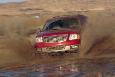 2003 Ford Expedition - 2003 Ford Expedition splashes through mud on an off-road trail.