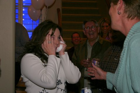 1966 Ford Bronco - A woman is emotional while friends celebrate with her at a party.