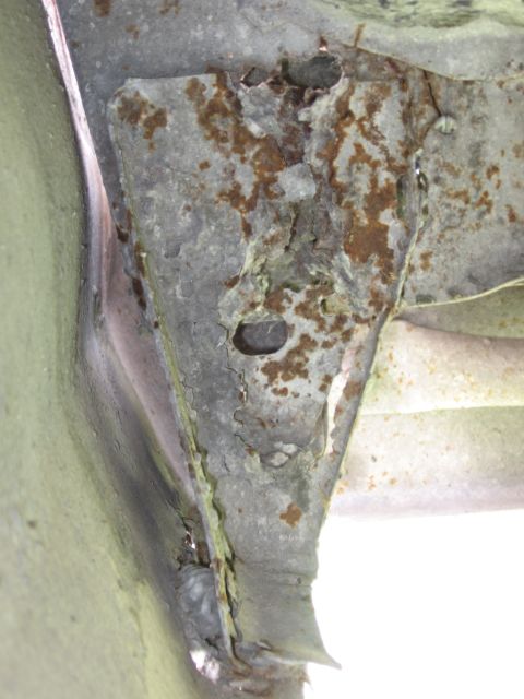 1974 Ford F-100 - Heavily rusted frame bracket shows significant corrosion and structural damage.